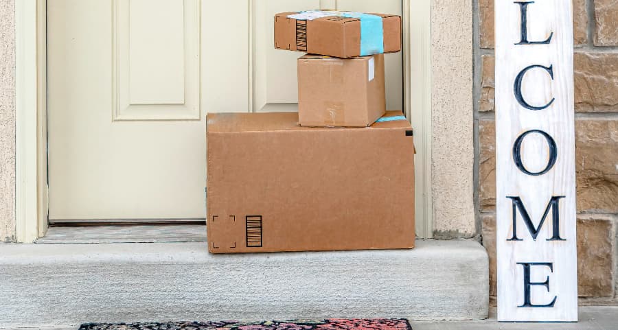 Packages on the doorstep of a home with a welcome sign in Washington, DC